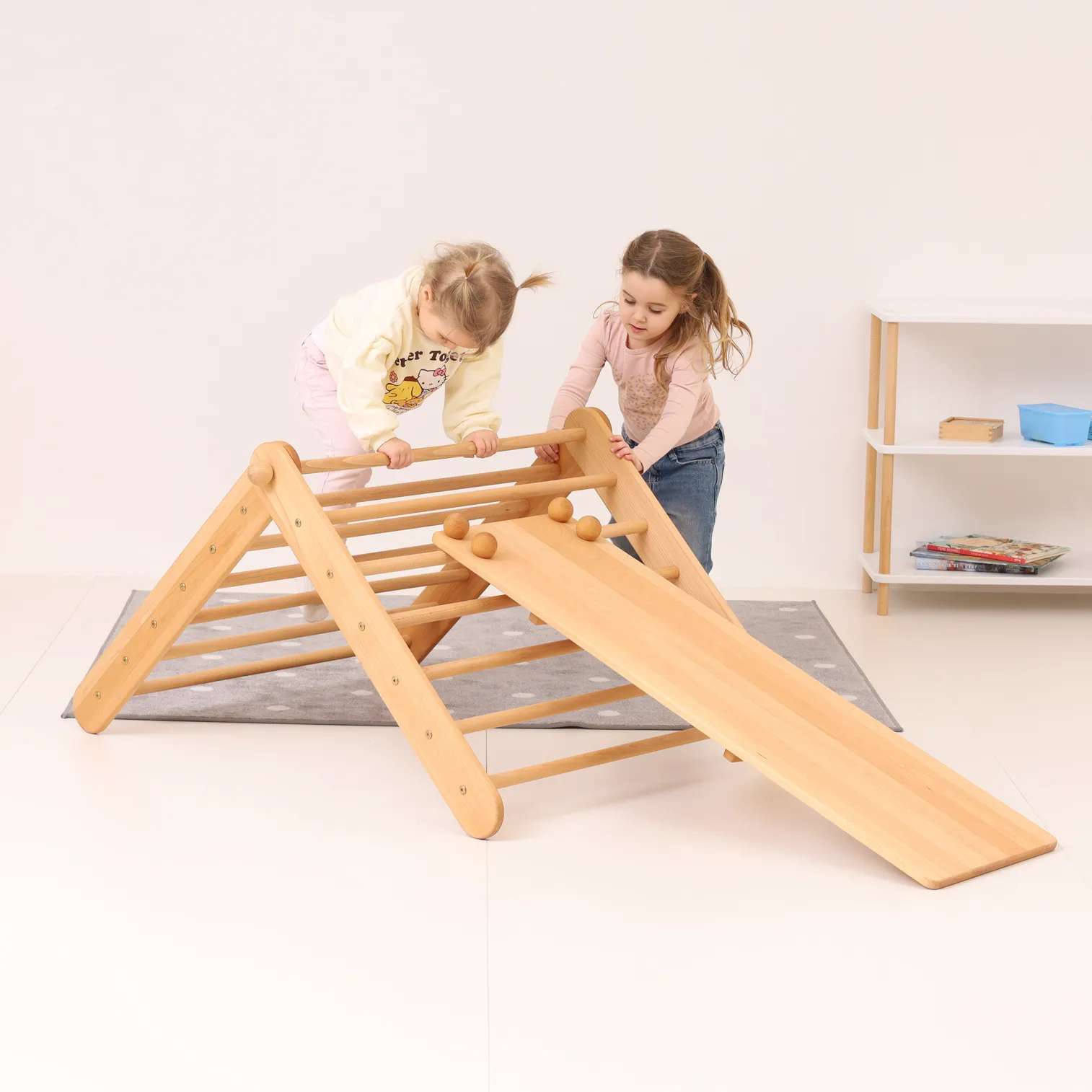 Two children playing together on CLIMBIE Montessori climbing triangle – indoor gross motor activity