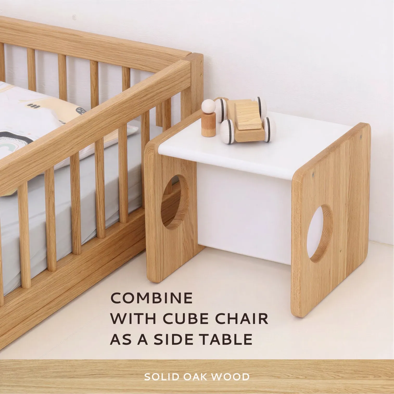 Side rail detail on solid oak Montessori floor bed for toddlers